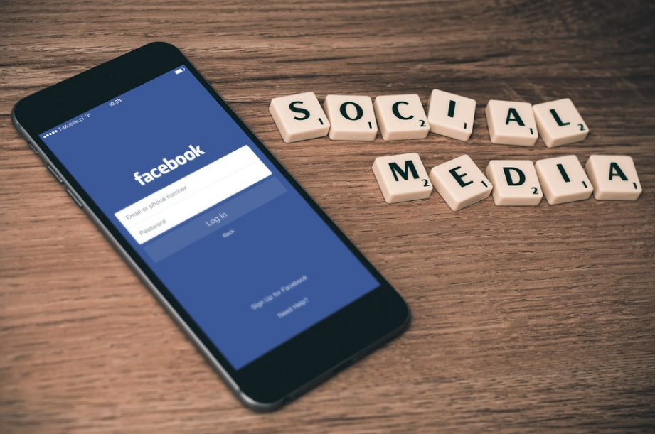 a smartphone on the table showing facebook page